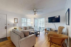 a living room with a couch and a table at Pelican Bay 46 in Isle of Palms