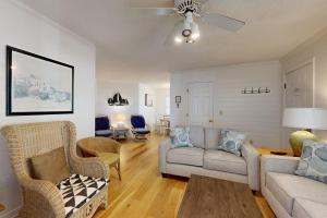 a living room with a couch and chairs at Pelican Bay 46 in Isle of Palms