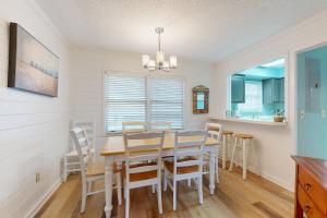 a dining room with a table and chairs at Pelican Bay 46 in Isle of Palms