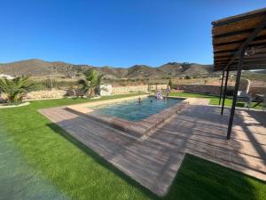 a swimming pool in the middle of a yard at La Casona de Piedra in Cartagena