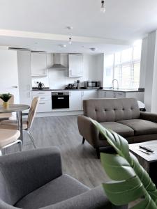 a living room with a couch and a table at Ascot House Apartments in Peterborough