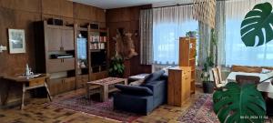 a living room with a blue couch and a table at Haus Ronna in Schruns