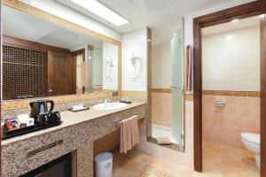un bagno con lavandino, water e specchio di Hotel Riu Funana - All Inclusive a Santa Maria