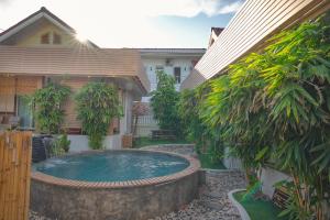 a swimming pool in the backyard of a house at Maduel Resort Kohlarn in Ko Larn