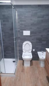 a bathroom with a shower and a toilet and a sink at Appartamento in Residence - Parco Nazionale d'Abruzzo in Pescasseroli +16 photos