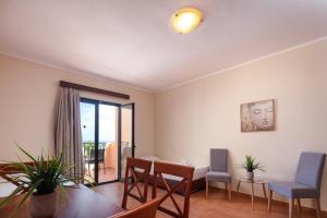 a living room with a dining room table and chairs at Dia Apartments in Hersonissos