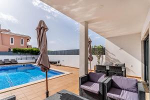 a villa with a swimming pool and a house at Villa Feliz Algarve with Private Pool - São Rafael in Albufeira