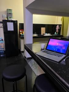 a laptop computer sitting on top of a counter at Salty Heart - Surf House in Weligama +38 photos