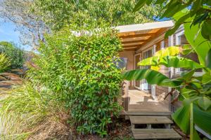 a house with a wooden walkway leading to the front porch at Camping Paradis 4 étoiles A La Corniche La Rochelle Angoulins in Angoulins-sur-Mer