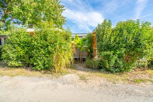 a group of bushes in front of a house at Camping Paradis 4 étoiles A La Corniche La Rochelle Angoulins in Angoulins-sur-Mer