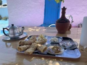 a table with a plate of food on a table at The Endless Enigma in Tazroutane +23 photos