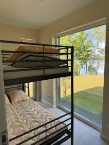 a bedroom with two bunk beds and a large window at Akmeni Nature Resort in Tome +60 photos