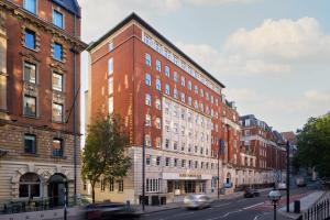 a tall red brick building on a city street at Four Points Flex by Sheraton London Euston in London