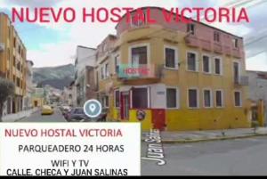 a poster for a hotel on a city street at Nuevo Hostal Victoria in Quito