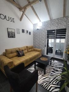a living room with a couch and a table at Kuća za odmor MERLIN HOUSE in Vrnjačka Banja