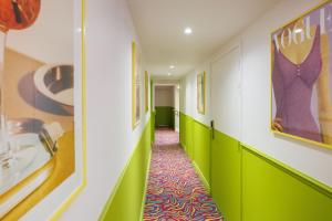 a hallway with green walls and a colorful carpet at Best Western Hotel Lakmi Nice in Nice