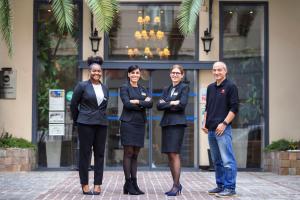 a group of people standing in front of a building at Best Western Hotel Lakmi Nice in Nice