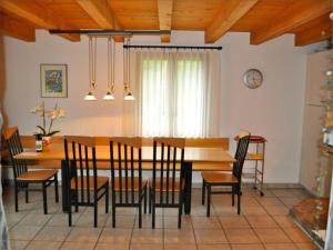 a dining room with a wooden table and chairs at Casa Fontanella in Brione