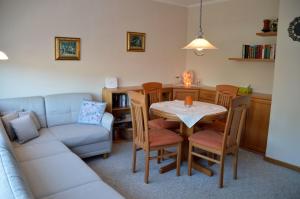 a living room with a table and a couch at Wiesenweg - Wohnung 06 in Wyk auf Föhr