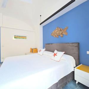 a bedroom with a white bed with two stars on it at Casa Infinito in Capri
