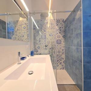 a bathroom with a white sink and a shower at Casa Infinito in Capri +24 photos