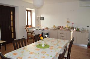 a kitchen with a table with a table cloth on it at B&B Alla Cà Di Rosa in Dossobuono