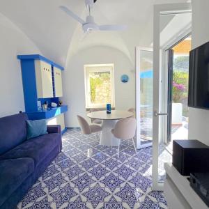 a living room with a couch and a table at Casa Infinito in Capri