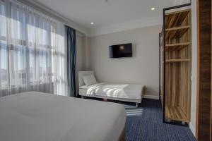 Postel nebo postele na pokoji v ubytování Hotel Resident Bishkek