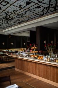 a buffet line with food on it in a restaurant at Parkhotel Mondschein, a Member of Design Hotels in Bolzano