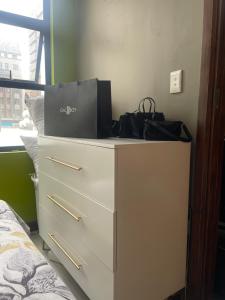 a white dresser with a bag on top of it at Feel at home in Durban