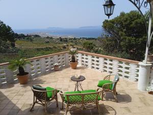 a patio with chairs and a table on a balcony at Il tempio sulle isole in Erice