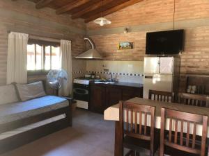 a kitchen with a couch and a table in a room at Complejo La Morena in Mina Clavero