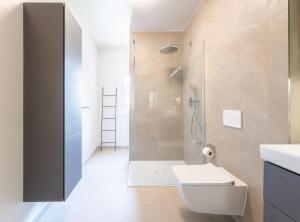 a bathroom with a shower and a toilet and a sink at Stockholm Style Designer in Limpertsberg in Luxembourg +18 photos