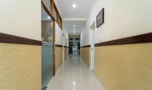 a hallway with wooden stalls in a building at Treebo Thoduvas Star Plaza Cochin Airport in Nedumbassery