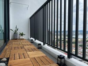 a balcony of a building with wooden floors and large windows at The Luxe Suite, Sunway City with 2Bedroom and Netflix in Subang Jaya