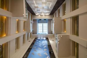 a hallway with a blue carpet in a building at Electra Metropolis in Athens
