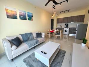 a living room with a couch and a table at The Luxe Suite, Sunway City with 2Bedroom and Netflix in Subang Jaya