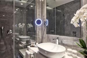 a bathroom with a sink and a shower at Electra Metropolis in Athens