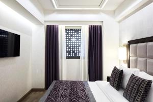 a hotel room with a bed and a window at Electra Metropolis in Athens