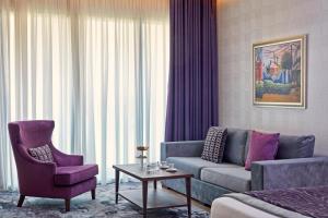 a hotel room with a couch and a chair at Electra Metropolis in Athens