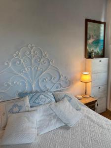 a bedroom with a large bed with a silver headboard at Circeo Mon Amour in San Felice Circeo
