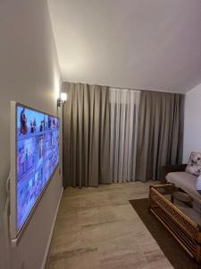 a living room with a large flat screen tv on a wall at The Bay View Boutique Hotel Kalkan in Kas