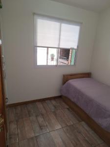 a bedroom with a bed and a window at Casa Monte hermoso Barrio las Dunas in Monte Hermoso