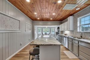 a kitchen with a wooden ceiling and a large island at Lake Haven Estate with Hot Tub, Game Room and Pontoon Boat, 4BR, 4 Bathoom, 2 Kitchens in Hot Springs