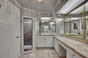 a bathroom with two sinks and two mirrors at Lake Haven Estate with Hot Tub, Game Room and Pontoon Boat, 4BR, 4 Bathoom, 2 Kitchens in Hot Springs +80 photos