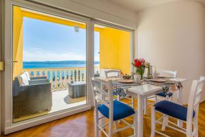 a dining room with a table and a view of the ocean at AKELAVA in Crikvenica