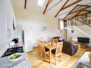 a kitchen and living room with a table and a stove at Turtle Cottage in Charlestown