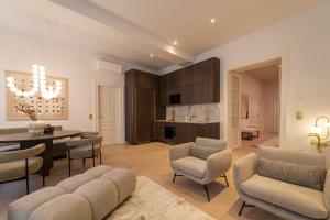 a living room with a table and chairs and a dining room at josef's home I Superior Suite I Quiet & Central in Vienna