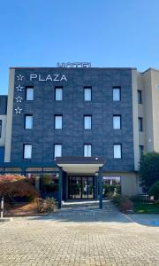 a hotel with a sign on the front of it at Hotel Plaza in San Martino Siccomario