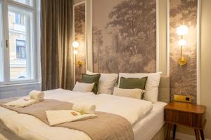a bedroom with a large bed with towels on it at josef's home I Superior Suite I Quiet & Central in Vienna